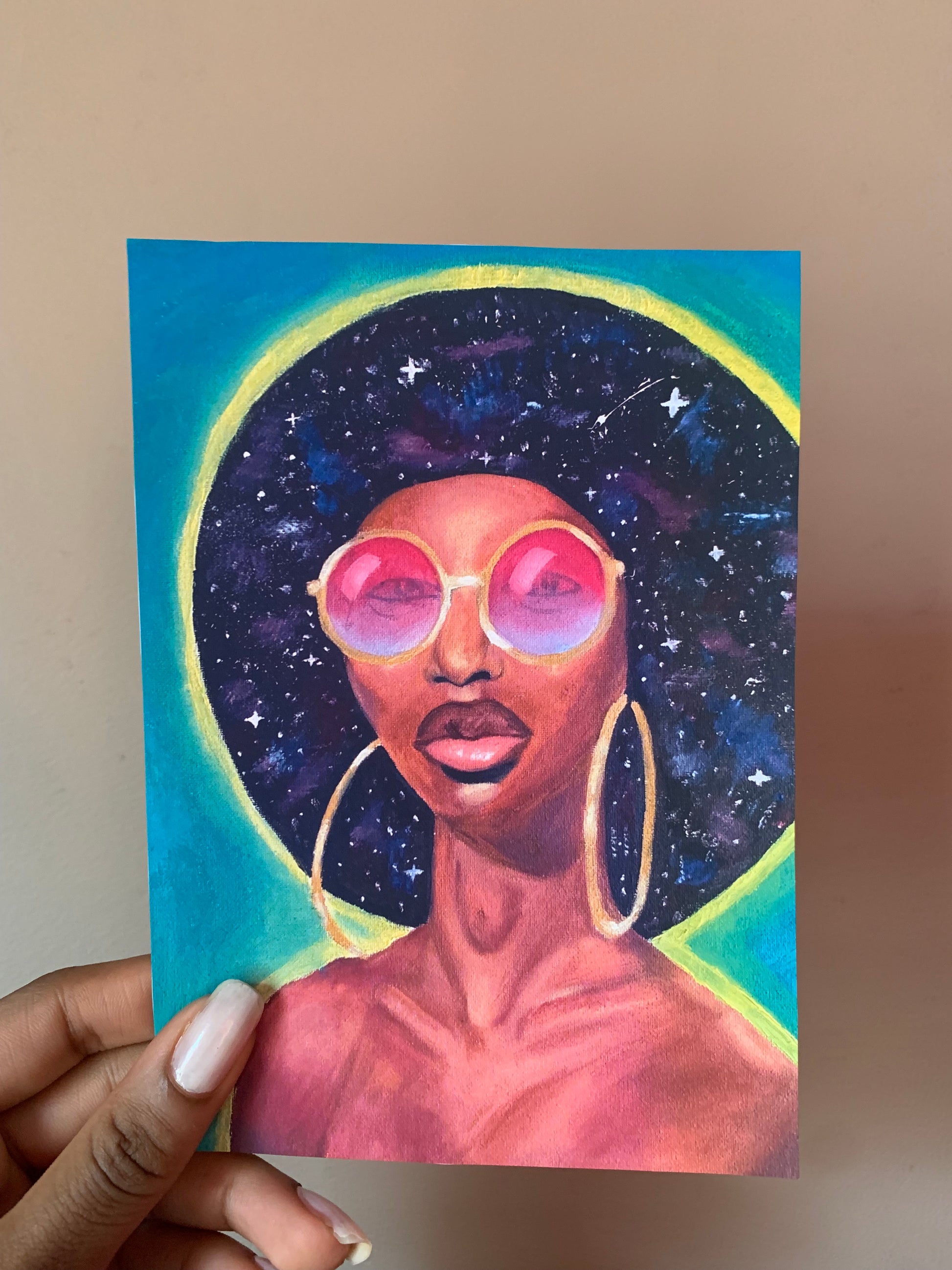 Artistic depiction of a person with a cosmic background held by a hand.